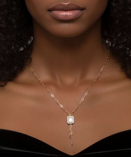 Woman wearing a Diamond necklace with a pendant against a neutral background