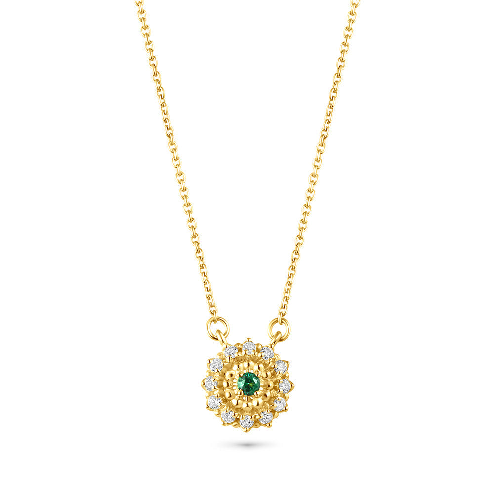 An 18K gold necklace with a central emerald stone surrounded by small diamonds, suspended from a gold chain.