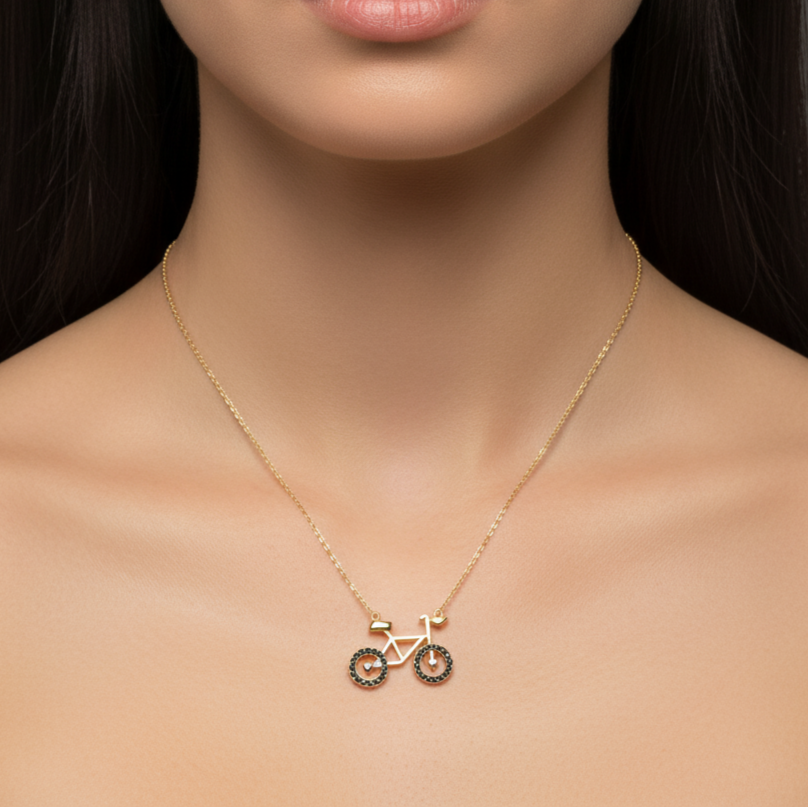 Gold necklace with a bicycle pendant
