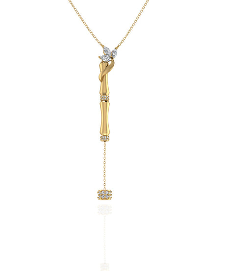 An 18k yellow gold single bamboo stalk pendant with a hanging diamond and decorative marquise
