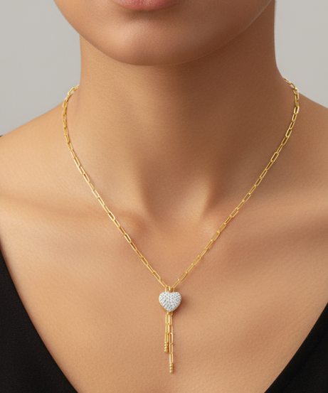 Diamond necklace with a heart-shaped pendant worn by a model against a neutral background