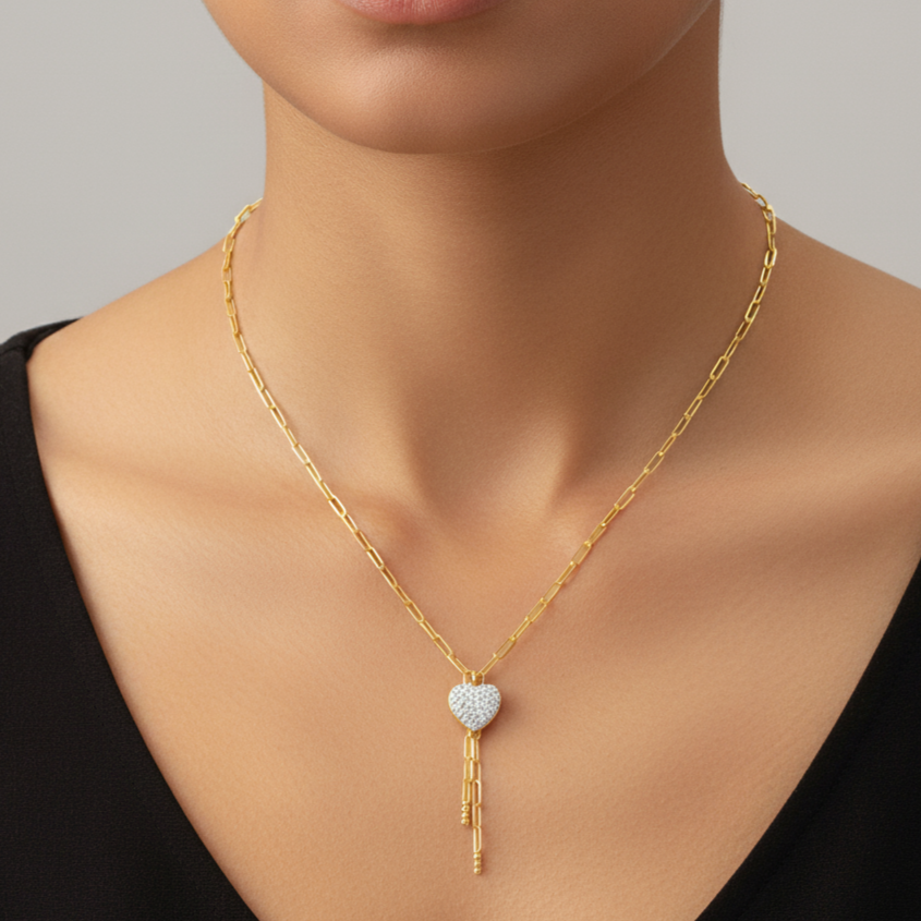 Diamond necklace with a heart-shaped pendant worn by a model against a neutral background